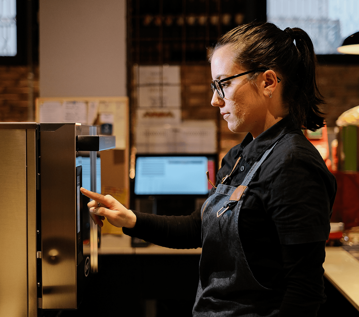 staff with commercial speed oven in bar